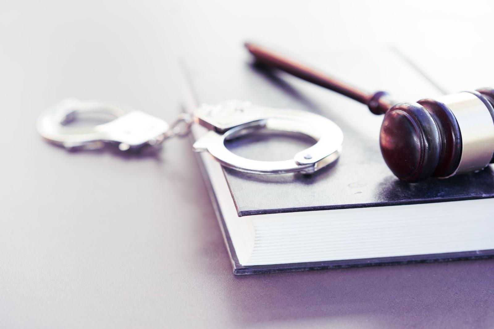 Handcuffs and gavel laid out during criminal justice procedures.